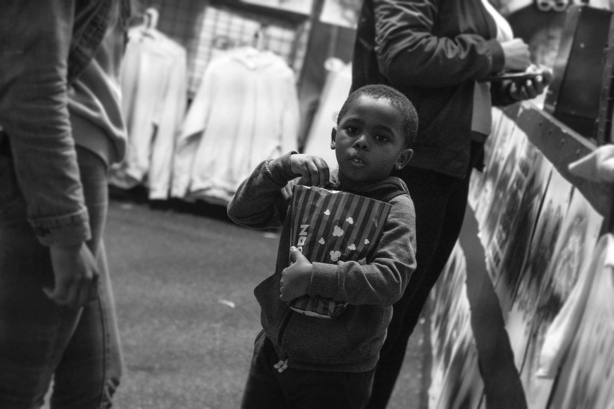 Black-and-white view of laundry hanging on a line, a small child below — Chapel Hill