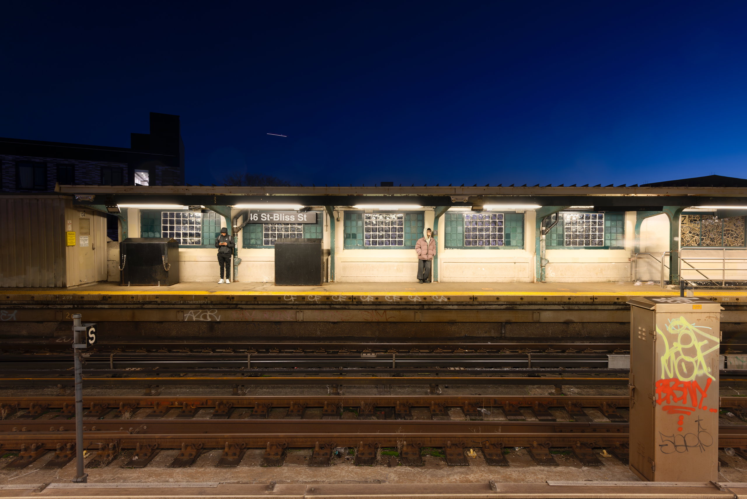 An elevated subway platform under a clear sky — Win or Lose