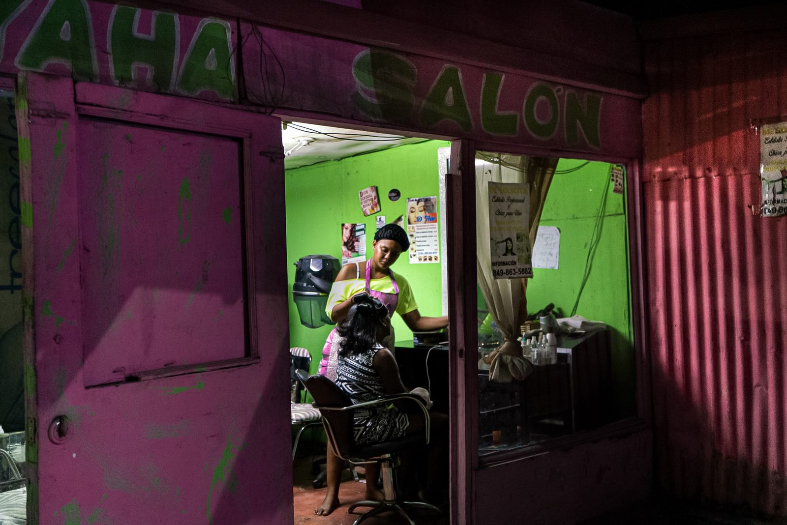 Inside a pink-walled room, people gathered — Punta Cana