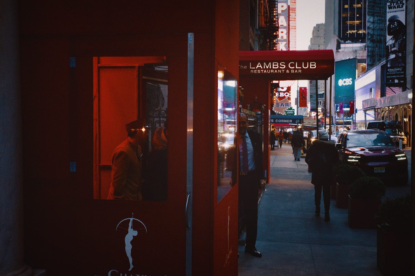 A dark interior looking out to a lit street — New York